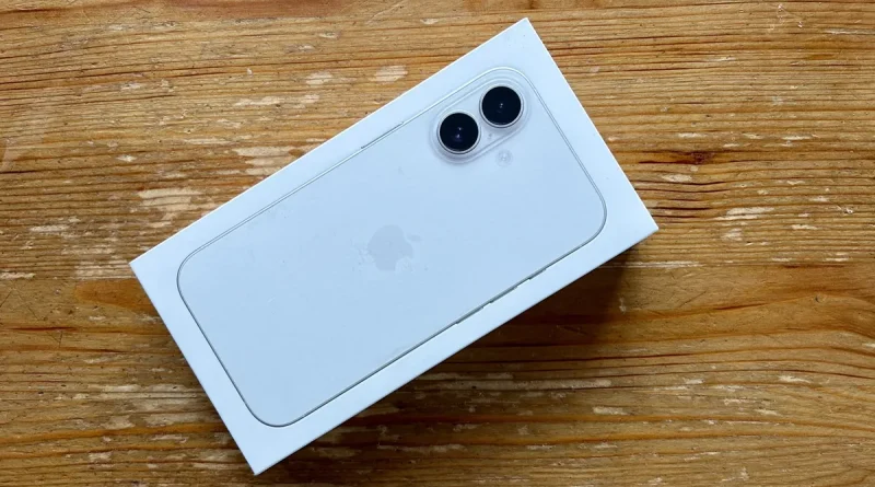 A white iPhone box lying on a wooden table