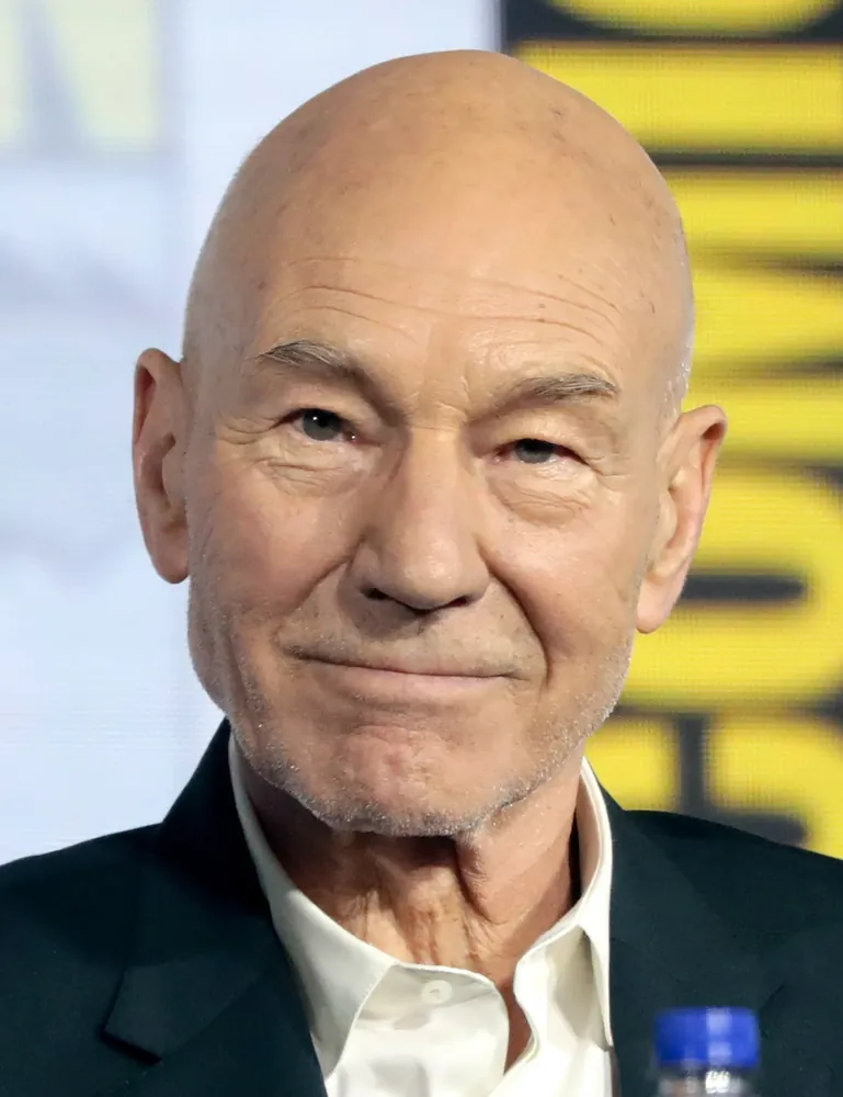 Close-up portrait of Sir Patrick Stewart smiling at a fan convention